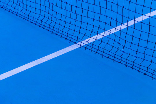 Blue tennis court surface, sport background..Detail of a tennis court.Tennis court with net background.