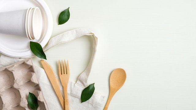 Eco friendly cotton bag, bamboo cutlery set, biodegradable paper utensils, egg carton and green leaves. Zero waste, plastic free concept. Sustainable lifestyle