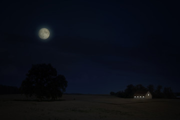 Moon over field of stubble at night. Abstract work.