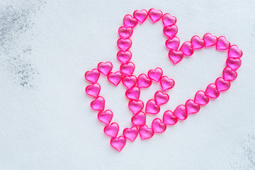 Two pink hearts made of plastic hearts