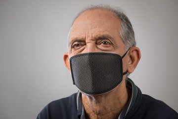 Portrait of a senior man wearing a pollution mask. (Health and Fitness) 