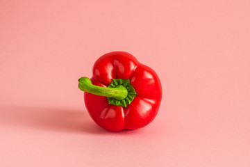 red bell pepper on pink background  minimalism composition