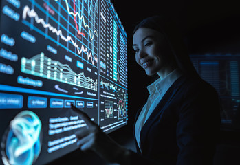 The business woman works with graphics on a sensor screen