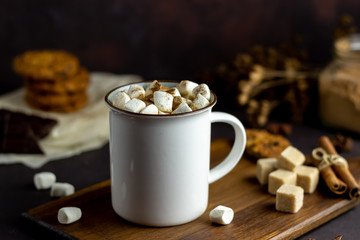 Hot chocolate with marshmallows in a white mug on a rusty background. Winter. Recipes.