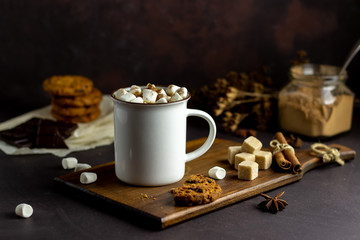 Hot chocolate with marshmallows in a white mug on a rusty background. Winter. Recipes.