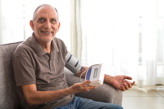 Senior Man Taking His Blood Pressure Test At Home. (Health And Fitness) 