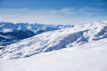 Fototapeta na wymiar Snowy Landscape With Mountains At Background