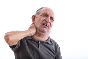 Obraz premium Senior man having a neck pain wearing a neck band. (Health and fitness) 