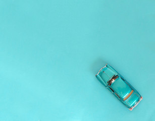 Blue car on a blue background with space copying. Car in retro style.