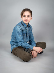 Teen boy sitting on the floor