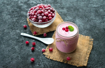 Healthy yogurt with frozen cranberry berries. The concept of healthy desserts.