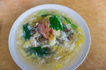 Delicious Chinese tradition food Flat rice noodle in egg gravy or well known as 'Wan Tan hor' with pork or seafood.most famous Chinese restaurant or food stalls.