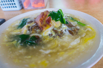 Delicious Chinese tradition food Flat rice noodle in egg gravy or well known as 'Wan Tan hor' with pork or seafood.most famous Chinese restaurant or food stalls.