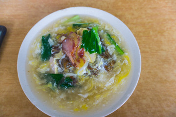 Delicious Chinese tradition food Flat rice noodle in egg gravy or well known as 'Wan Tan hor' with pork or seafood.most famous Chinese restaurant or food stalls.