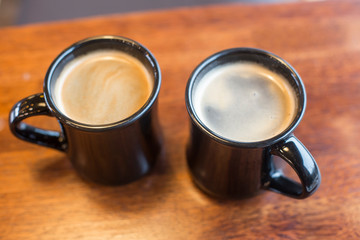 Two cup of hot coffee on wooden table