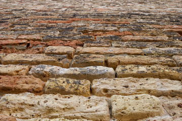 Ancient stone wall texture with orange-brown cast.