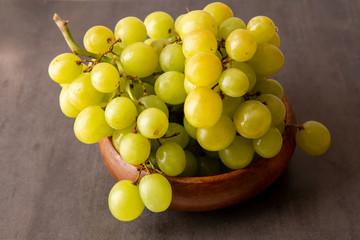 Green grapes in the wooden bowl