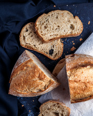 Sliced grain bread on dark blue background