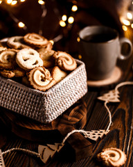 Christmas cookies in wicker basket  on dakr brown wooden background