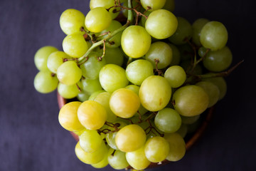 Green grapes in the wooden bowl