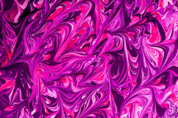 Abstract background of pink, purple and black paint swirls