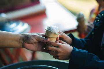 Providing free food to the poor Volunteers scooping out food to give charity to those who are...