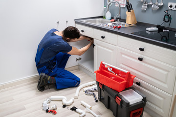 Male Plumber Fixing Sink Pipe - obrazy, fototapety, plakaty