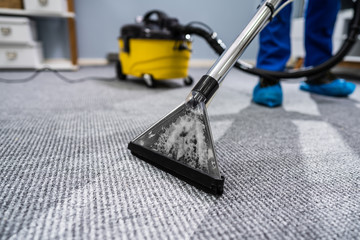 Person Cleaning Carpet With Vacuum Cleaner - obrazy, fototapety, plakaty