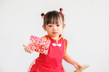 Chinese New Year festival concept, Portrait image of 1-2 yeas old baby. Happy Asian Chinese 's baby girl in the red clothes. She holding a pocket money gift in her hand. On white background.