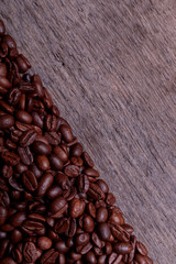 Coffee beans on old vintage wooden background with copyspace for text. Coffee background or texture concept.