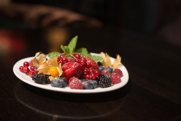 plate with fresh fruits and berries