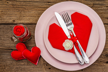 Romantic dinner table. Love concept for Valentine's or mother's day, wedding cutlery. Vintage wooden boards background