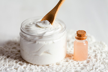 Concept of natural fruity organic ingredients in cosmetology. Extract of grapefruit for moisturizing, delicate skin nutrition, pore narrowing and anti-cellulite effect. Wooden background, copy space