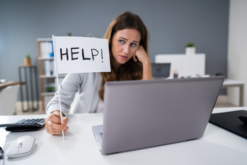 Businesswoman Showing Help Flag In Office