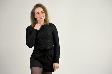 Concept woman smiling talking. Portrait of a model girl with excellent makeup with short hair and good teeth in the studio on a white background.