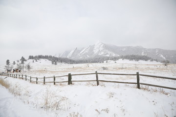 Long run of fence in a snowy landscape near Denver, Colorado