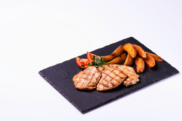 grilled meat and fried potatoes and fresh vegetables5