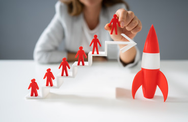 Red Rocket Beside Red Human Figure On Increasing Arrow