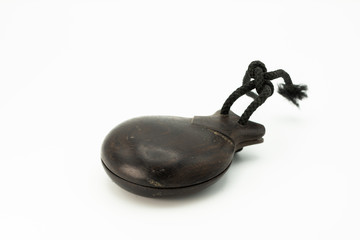 Wooden castanets lying on a white underground