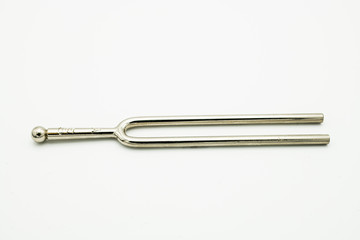 A tuning fork 440 Hz on a white background