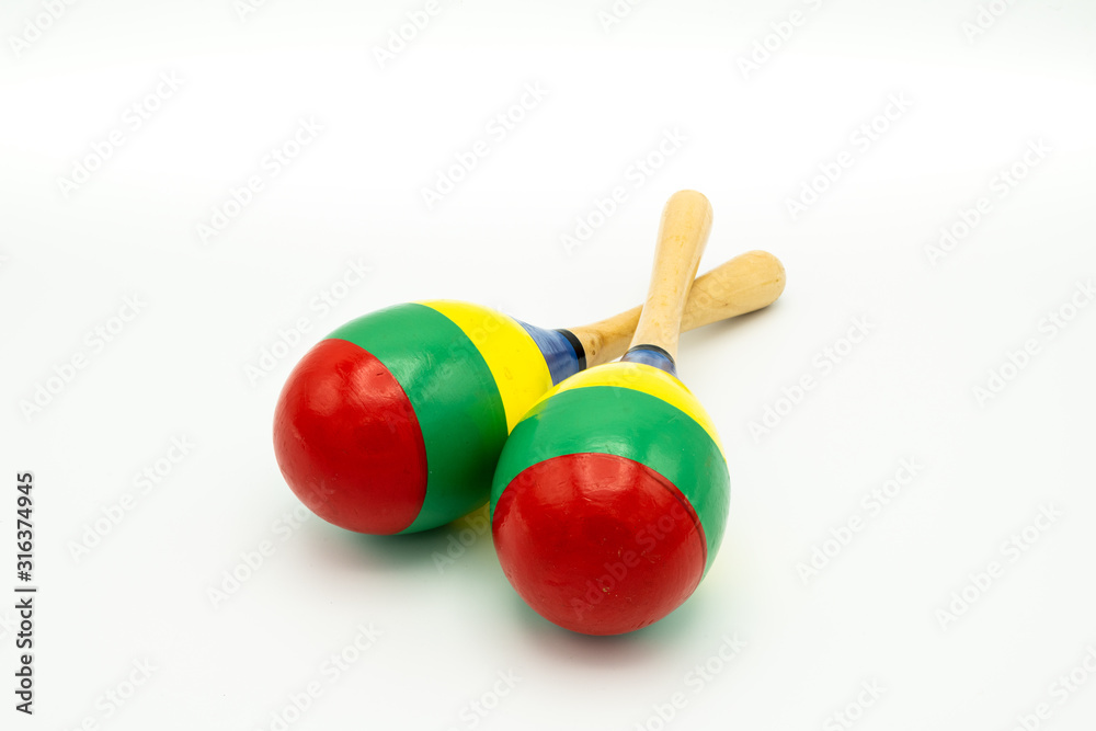 Wall mural A pair of colorful maracas lying on a white underground