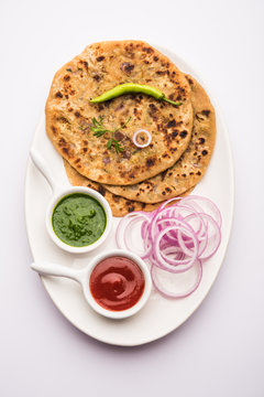 Onion Parotha / Pyaj parantha / kanda paratha served with tomato ketchup and green chutney. selective focus