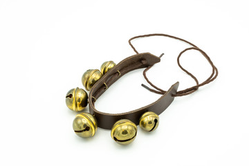 Jingles on a leather band lying on a white underground