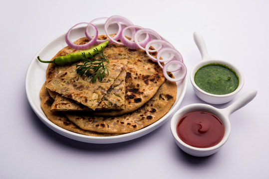 Onion Parotha / Pyaj parantha / kanda paratha served with tomato ketchup and green chutney. selective focus