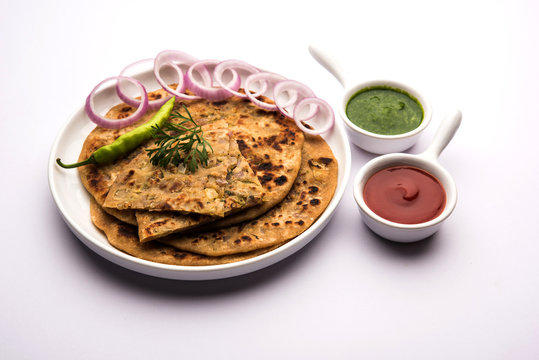 Onion Parotha / Pyaj parantha / kanda paratha served with tomato ketchup and green chutney. selective focus