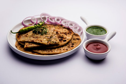 Onion Parotha / Pyaj parantha / kanda paratha served with tomato ketchup and green chutney. selective focus