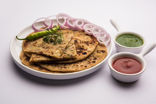 Onion Parotha / Pyaj parantha / kanda paratha served with tomato ketchup and green chutney. selective focus