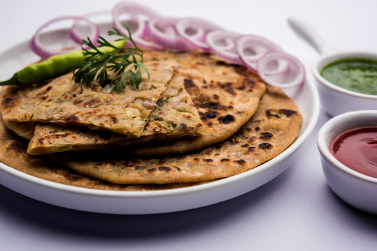 Onion Parotha / Pyaj parantha / kanda paratha served with tomato ketchup and green chutney. selective focus