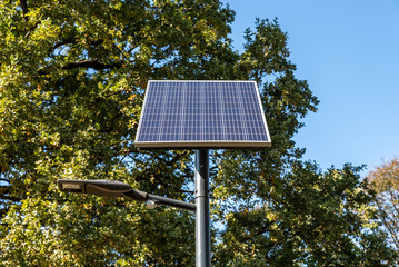 Modern new street LED light powered by solar panel with cells charging on the sun 