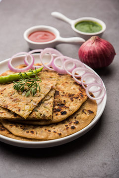 Onion Parotha / Pyaj parantha / kanda paratha served with tomato ketchup and green chutney. selective focus